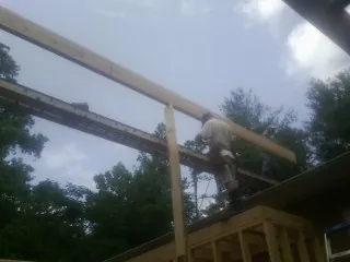 Carpenter setting a ridge beam over a new addition frame — Ice Dam Removal by Roofing Brothers in Oak Brook